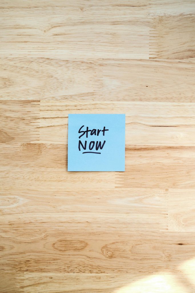 pexels-photo-29546581-29546581 Blue Post-It note with 'Start Now' on light wooden background, inspiring action.