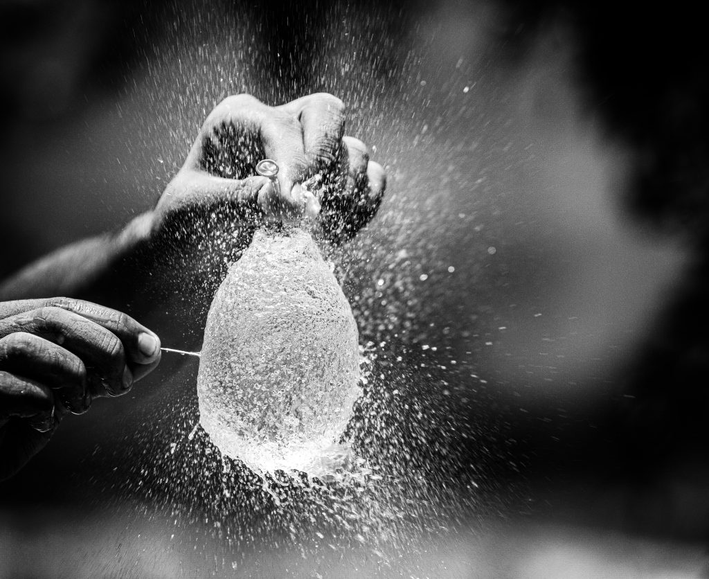 pexels-photo-7667242-7667242 Captivating moment of a water balloon explosion captured in monochrome, showcasing motion and texture.